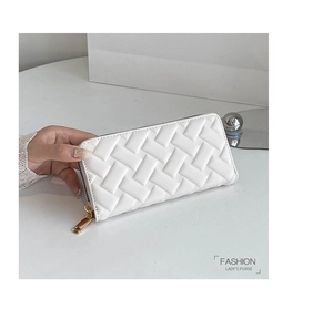 Macro view of white embossed woven leather wallet with golden metal zipper detail