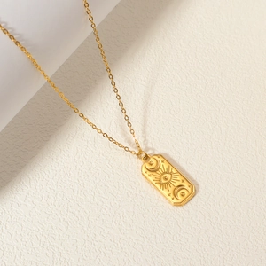 Gold plated stainless steel necklace featuring engraved sun and moon rectangle pendant