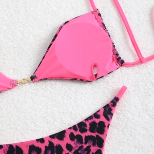 Detail of neon pink leopard bikini showing the golden metal ring and inner lining