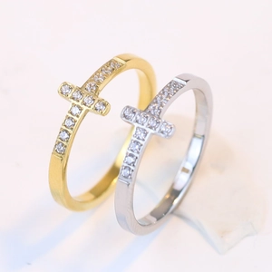 Detailed close-up of 7mm stainless steel cross rings with cubic zirconia in gold and silver