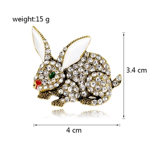 Golden rabbit brooch with sparkling rhinestones and white enamel details for women