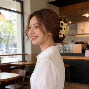 Close-up of a yellow hollow cheese shaped hair claw clip styled on a low bun hairstyle