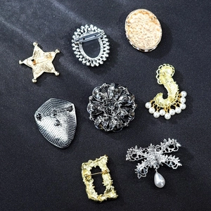 Detailed back view of vintage brooches with alloy structure and safety pin clasp design