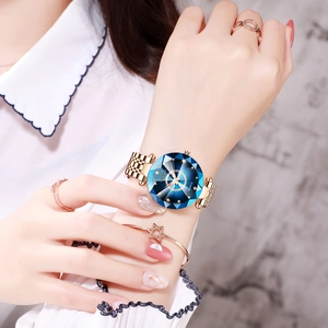 Close-up of women's starry blue diamond-cut watch with rose gold strap and jewelry set