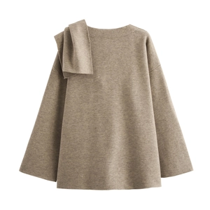 Detail of a brown knit cardigan with a stylish scarf-style bow knot on the shoulder