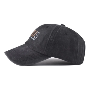 Detail of vintage washed black cotton cap with orange US lettering and embroidery