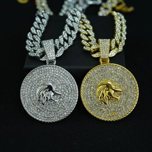 Detailed view of silver and gold Leo zodiac necklaces with lion head pendants and Cuban chains