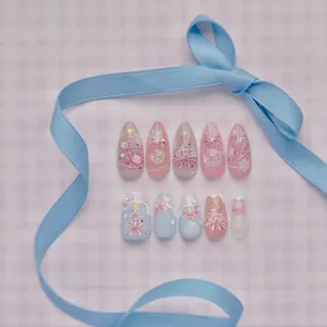 Christmas press-on nails set with 3D pink bows, snowflakes, and festive tree designs