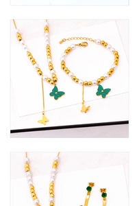 Detail of butterfly jewelry set with green malachite texture and gold bead chain