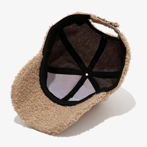 Detail view of khaki fleece baseball cap interior with sweatband and adjustable strap