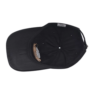 Detail view of cotton baseball cap interior showing wash label and adjustable metal buckle