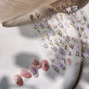 Fairy style butterfly and tulip nail stickers with iridescent laser effect on pink nails