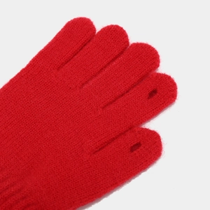 Detail of red knit gloves with functional finger openings for smartphone touchscreen use