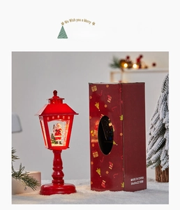 Close-up of a red Christmas snow globe lantern with santa claus and 84x84x221mm gift box