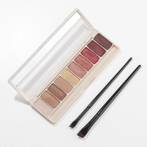 Detailed view of 10-color eyeshadow palette with mirror and two angled makeup brushes