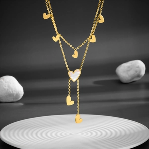Gold-tone layered heart necklace with mother of pearl inlay and elegant fringe tassels