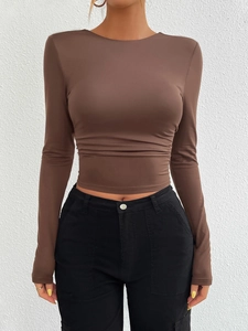 Detail of slim fit brown long sleeve knitted top for women showing stretch fabric texture