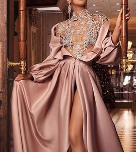 Detail view of pink satin evening gown with crystal mesh bodice and high leg slit