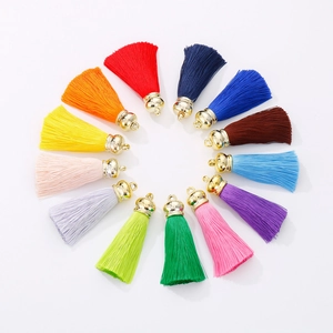 Colorful cotton fringe tassels with golden stainless steel caps arranged in a circle