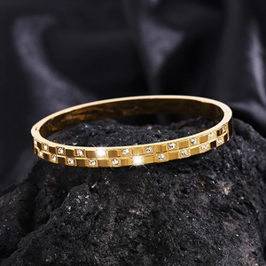 Golden waffle pattern titanium steel bracelet with double row diamonds on dark stone