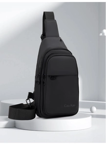 Waterproof matte black men's chest bag with dual zippers and adjustable strap on white pedestal