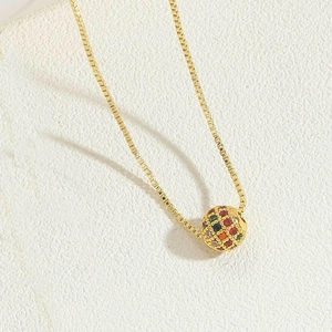 Detail of 18K gold box chain necklace with a colorful pavé-set round ball pendant