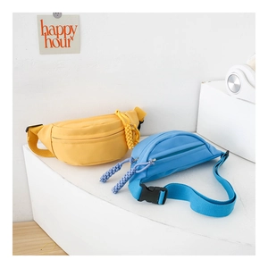 Detail of canvas chest bag featuring adjustable strap and woven rope zipper pulls