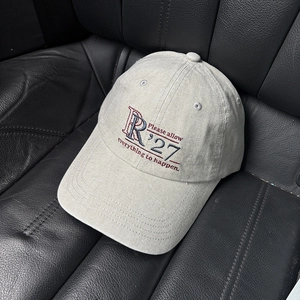 Close-up of R'27 embroidery on washed canvas baseball cap with refined stitching