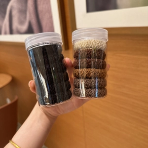Two jars of durable high-elastic hair ties in black and earth tones for high ponytails