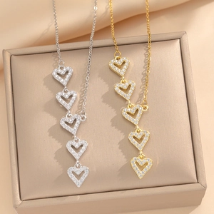 Luxurious stainless steel heart fringe necklace with five sparkling crystal heart pendants