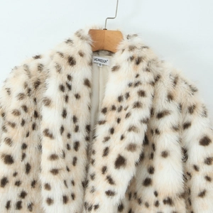 Vintage leopard print faux fur long coat in beige with brown spots on a wooden hanger