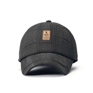 Detail of grey quilted winter baseball cap with waterproof fabric and leather patch