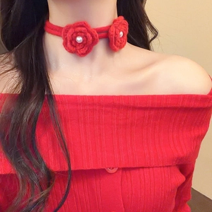 Detail of red crochet flower choker featuring 3D knitted roses and white pearls