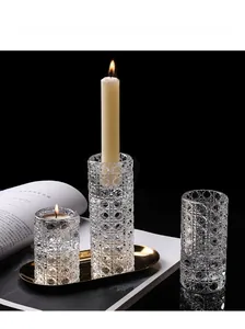 Detailed close-up of textured glass candle holders on a premium golden metal tray