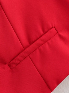 Macro shot of the red halter top featuring high-quality twill fabric and a neat welt pocket