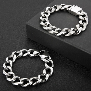 Macro view of silver steel Cuban link bracelets with square and lobster clasps