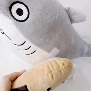 Close-up of shark plush toy made of crystal soft fabric with small brown accessory