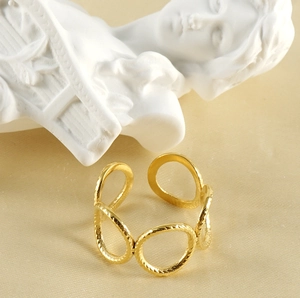Artistic detail of gold link ring with hammered texture on warm artistic background