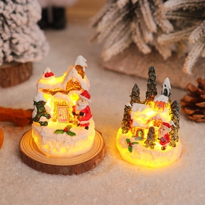 Close-up of hand-painted resin Christmas miniature with LED lights and snow-covered detail