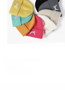 Detailed knit texture and bow embroidery on multi-colored winter beanies