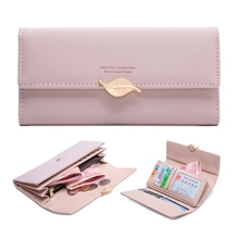Detail view of pink leather wallet showing card slots and golden leaf buckle closure