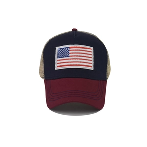Detail of USA flag embroidery on a vintage navy and burgundy trucker hat with mesh