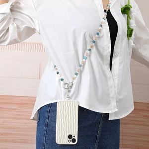 Colorful crystal beaded crossbody phone strap with white wavy case shown on a model