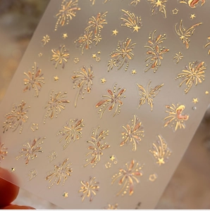 Macro shot of 3D gold embossed firework nail stickers with butterflies and stars
