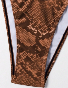 Close-up of the snakeskin pattern and high-elastic fabric stitching on the swimsuit