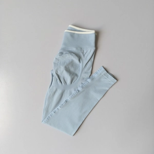 Detail of high waist light blue yoga leggings with ribbed texture and peach lift contour