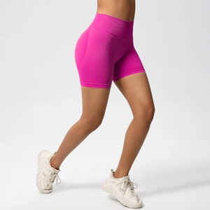 Detailed side view of high-waist seamless rose red fitness shorts on model