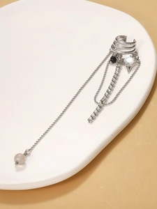 Detail of silver long tassel ear cuff with sparkling rhinestones and delicate metal chains