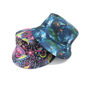 Double-sided reversible bucket hat with paisley and ghost ship patterns in flat lay view