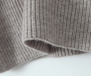 Detailed macro shot of ribbed knit fabric texture and soft sleeve cuff finish